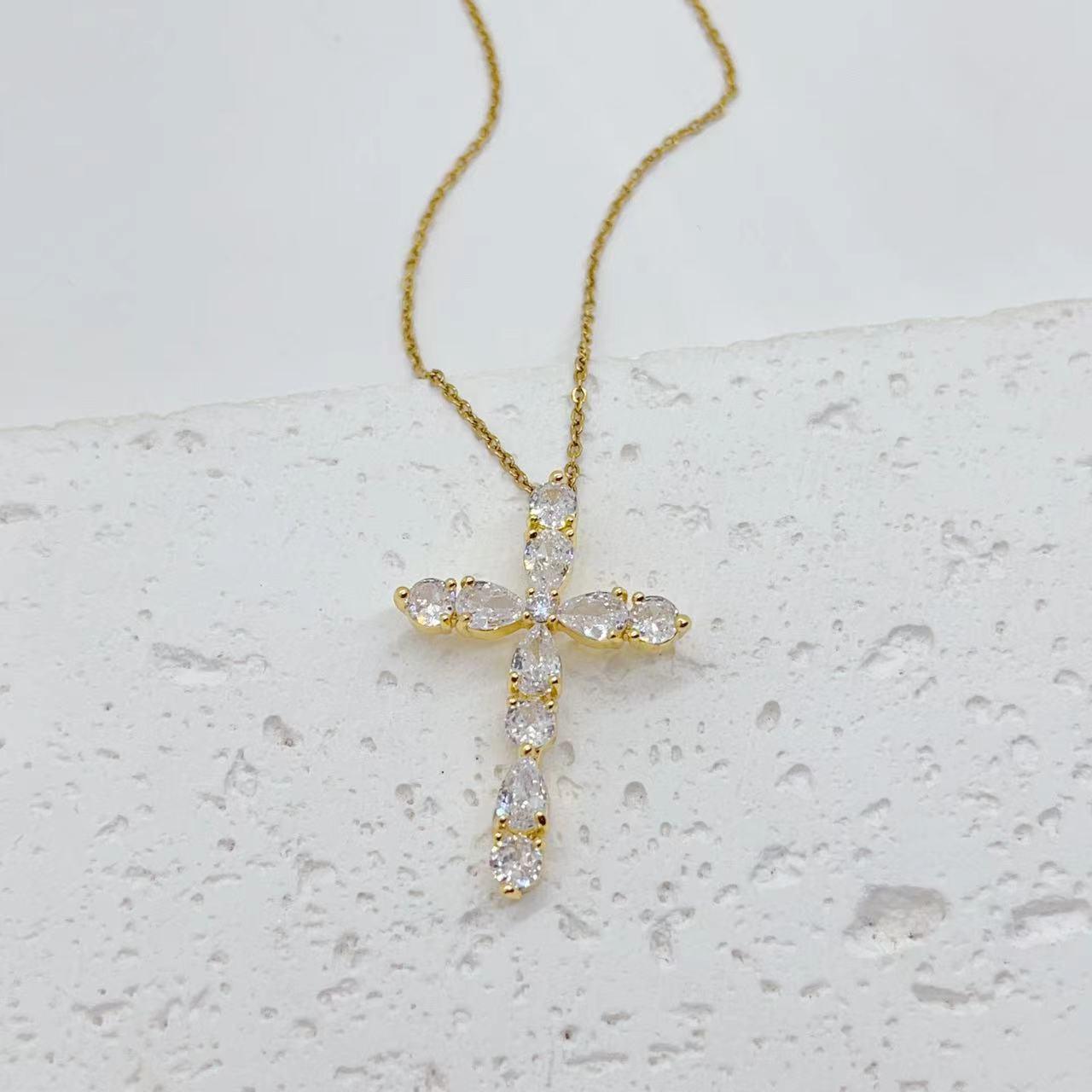 Adorn yourself with our Fashion Jewelry Micro Inlay Colorful Zircon Water Drops Cross Necklace for a vibrant and stylish accessory.