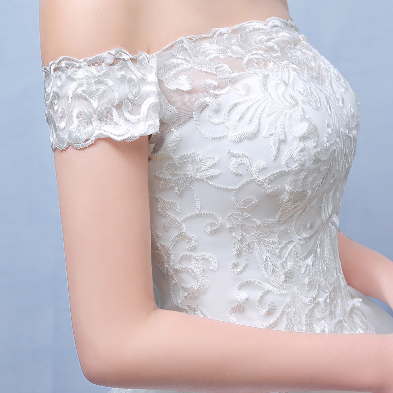 In the summer, envision a bride adorned in a bespoke lace wedding dress, accentuating her shoulders with elegance.