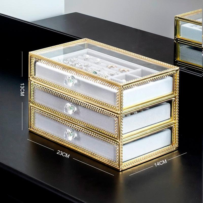 Keep your jewelry in style with our Copper-Edged Glass Jewelry Box, designed to organize earrings, rings, and necklaces with elegance.